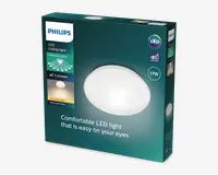 Emballagen viser en rund, hvid loftslampe med et glat og minimalistisk design. Det er en LED-armatur med en effekt på 17 watt, som giver varmt hvidt lys. Kassen fremhæver funktioner som indflettet optik for jævn lysfordeling og EyeComfort-teknologi for reduceret blænding og behagelig belysning. Produktet er fra Philips og er designet til at være skånsomt for øjnene.