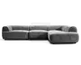 Lav, grå betrukket hjørnesofa med afrundede armlæn, tre store siddehynder og en chaiselong-lignende forlængelse på højre side.