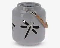 En rund, blank keramiklanterne med udskåret guldsmed-design på siden. Lanternen er lysegrå og har et robust rebhåndtag, der er fastgjort med metalbeslag. Øverst på lanternen sidder et solpanel, hvilket viser, at den er solcelledrevet til belysning.