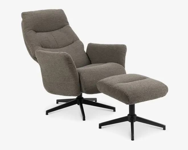 En moderne loungestol med tilhørende fodskammel, begge polstret med gråt tekstureret stof. Stolen har en høj, vinklet ryg med diskret polstring, brede armlæn og en tyk, komfortabel siddepude. Både stol og skammel har solide sorte metalbaser med fire ben, der giver stabilitet.