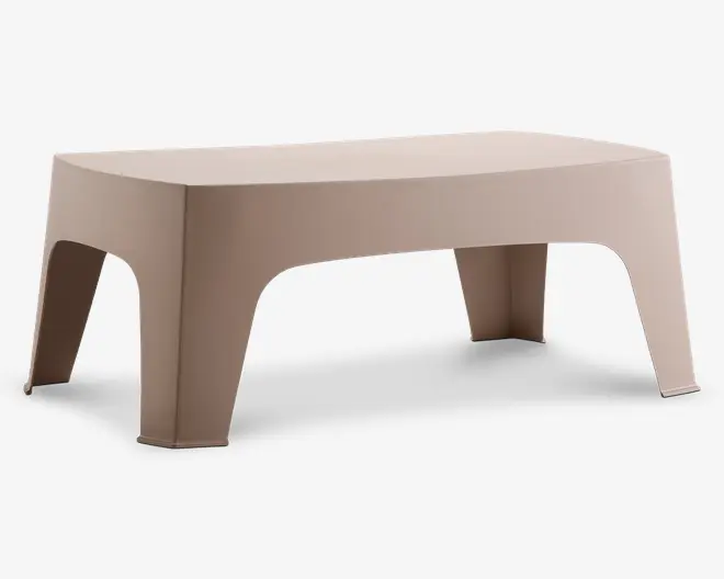 Rektangulært bord med en glat, mat beige overflade. Bordet har blødt buede kanter og fire brede, udadskrånende ben, der giver stabilitet. Designet er minimalistisk og moderne med et sømløst, støbt udseende uden synlige samlinger eller beslag.