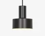 En moderne pendellampe med en mat sort, cylindrisk krop og en bred, flad bundskærm. Designet er minimalistisk med rene linjer og en glat overflade. Lampens inderside er hvid, hvilket hjælper med at reflektere lyset nedad for fokuseret belysning. Lampen hænger fra en lige sort ledning eller stang.