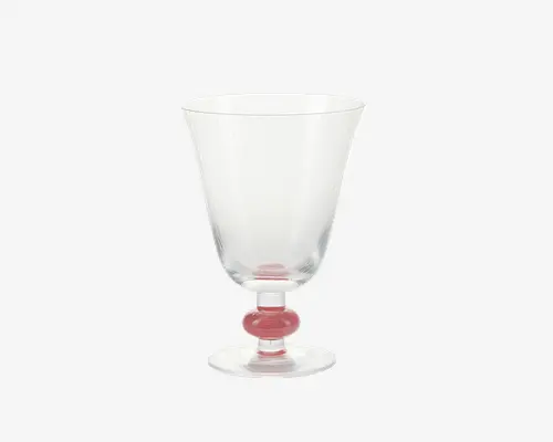 Klar glas med bred, let udadgående skål og kort stilk. Stilken har en markant rund, lyserød detalje nær bunden, som tilføjer et farverigt og elegant præg. Foden er flad og rund, hvilket giver stabilitet.