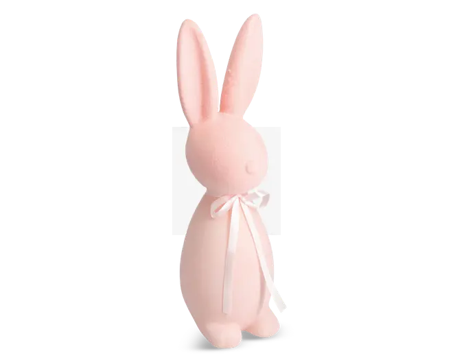 En blød, lyserød kaninfigur med lange opretstående ører og en glat, rund krop. Kaninen har minimale ansigtstræk og er pyntet med en fin hvid satinbånd, der er bundet i en sløjfe omkring halsen.