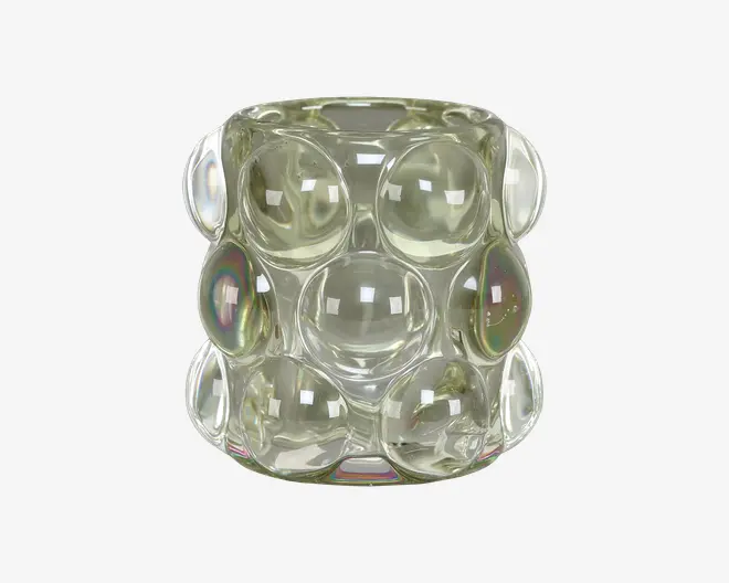 Et klart glasobjekt med cylindrisk form, der har en overflade med store, buede boblelignende forhøjninger arrangeret i et gittermønster. Glasset har en let iriserende finish, som reflekterer lyset og skaber diskrete regnbueeffekter på nogle af boblerne. Udseendet er moderne og dekorativt.