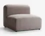 Armløs loungestol med et minimalistisk, moderne design, der har et tykt, rektangulært sæde og en afrundet ryglæn. Stolen er polstret med et tekstureret, lysebrunt stof og har en lav profil samt et blødt, polstret udseende for komfortabel siddeoplevelse.