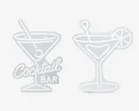 Sæt med to skilte i neon-stil formet som cocktailglas. Det ene skilt viser et martiniglas med en rørepind og en oliven samt teksten 'Cocktail Bar' i kursiv og blokbogstaver ved foden. Det andet skilt forestiller et lignende glas med en rørepind og en citron- eller limeskive på kanten. Begge skilte har en hvid kontur og er designet til at ligne lysende neonlys.