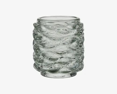 Klar glasbeholder med cylindrisk form og en tekstureret, bølget overflade. Glasset er tykt og har hævede, organiske mønstre, der giver et taktilt og visuelt interessant udtryk. Kanten er glat og let afrundet, og bunden er flad for stabilitet.