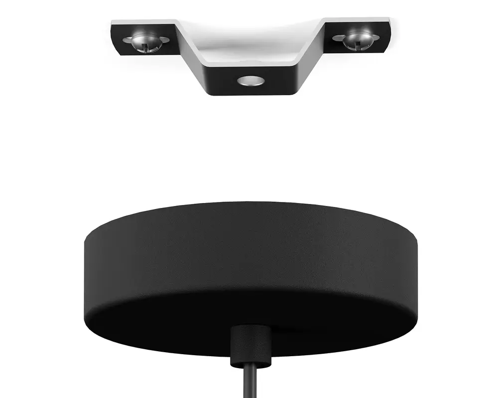 Nærbillede af en mat sort, cylindrisk loftroset med et centralt kabelindgangspunkt. Over den ses et metalbeslag med to skruehuller til sikker montering. Rosetten har en glat overflade og er designet til at skjule elektriske forbindelser for et rent og moderne udseende.