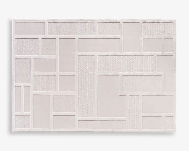 Rektangulært panel med et geometrisk mønster af forskellige størrelser rektangler og firkanter, hvor hver sektion er fyldt med forskellige teksturerede materialer. Den overordnede farve er en blød, lys beige, og designet er indrammet af en tynd kant. Teksturerne i felterne varierer fra glatte til let rillede, hvilket giver både visuel og taktil interesse.