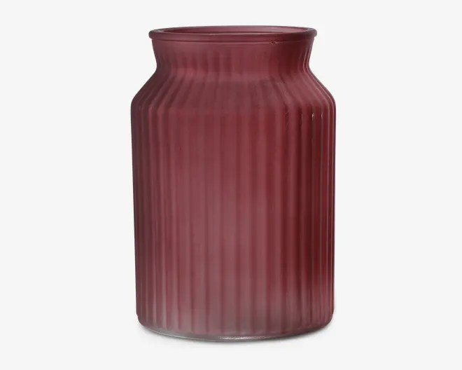 Høj cylindrisk beholder lavet af mat glas i en afdæmpet rosa farve, med lodret rillet tekstur langs siderne og en let udvidet kant øverst.