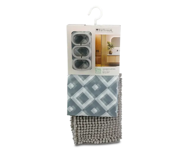 Sættet indeholder et badeforhæng med geometrisk diamantmønster i blå og hvide nuancer, tre ovale gardinringe i en gennemsigtig æske samt en bademåtte med bløde, grå chenille-løkker for ekstra komfort og sugeevne.