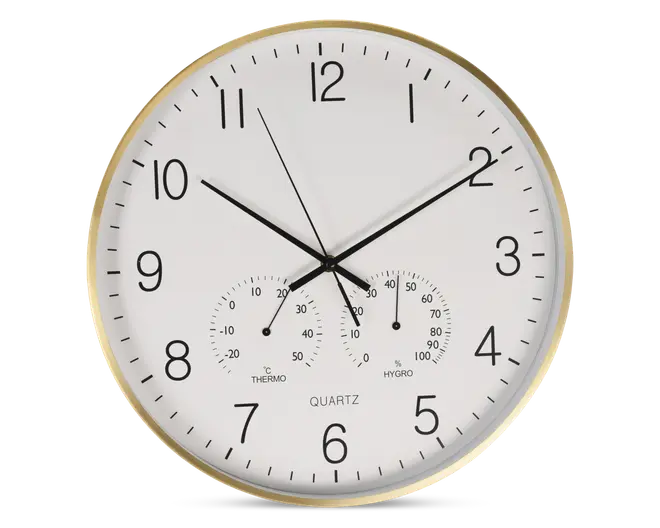 Rund vægur med hvid urskive, sorte time- og minutvisere samt en tynd sort sekundviser. Store sorte arabiske tal markerer hver time, og der er minutmarkeringer langs kanten. Uret har også to små målere nederst: én til temperatur (termometer) i grader Celsius og én til luftfugtighed (hygrometer) i procent. Rammen er i metallisk guld.