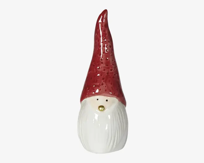 Blank hvid keramisk figur med en høj, spids rød hat med struktur, små sorte øjne og en lille gylden næse over et langt, flydende skæg.
