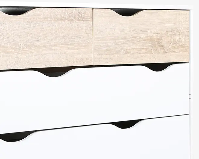 Nærbillede af et moderne kommode med to øverste skuffer i lyst trælook og to større nederste skuffer i mat hvid. Hver skuffe har et sort, buet udskæringsgreb, hvilket giver et stilrent og grebsløst udtryk. Designet kombinerer naturlige og minimalistiske elementer for et moderne udseende.